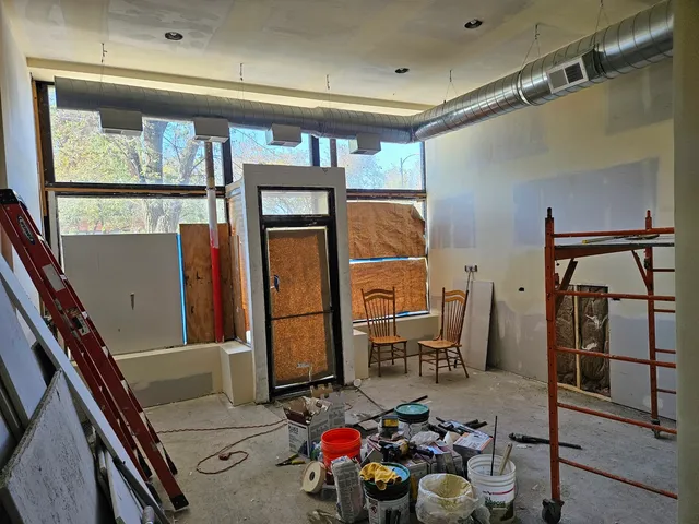 a kitchen with stainless steel appliances granite countertop a refrigerator stove and white cabinets