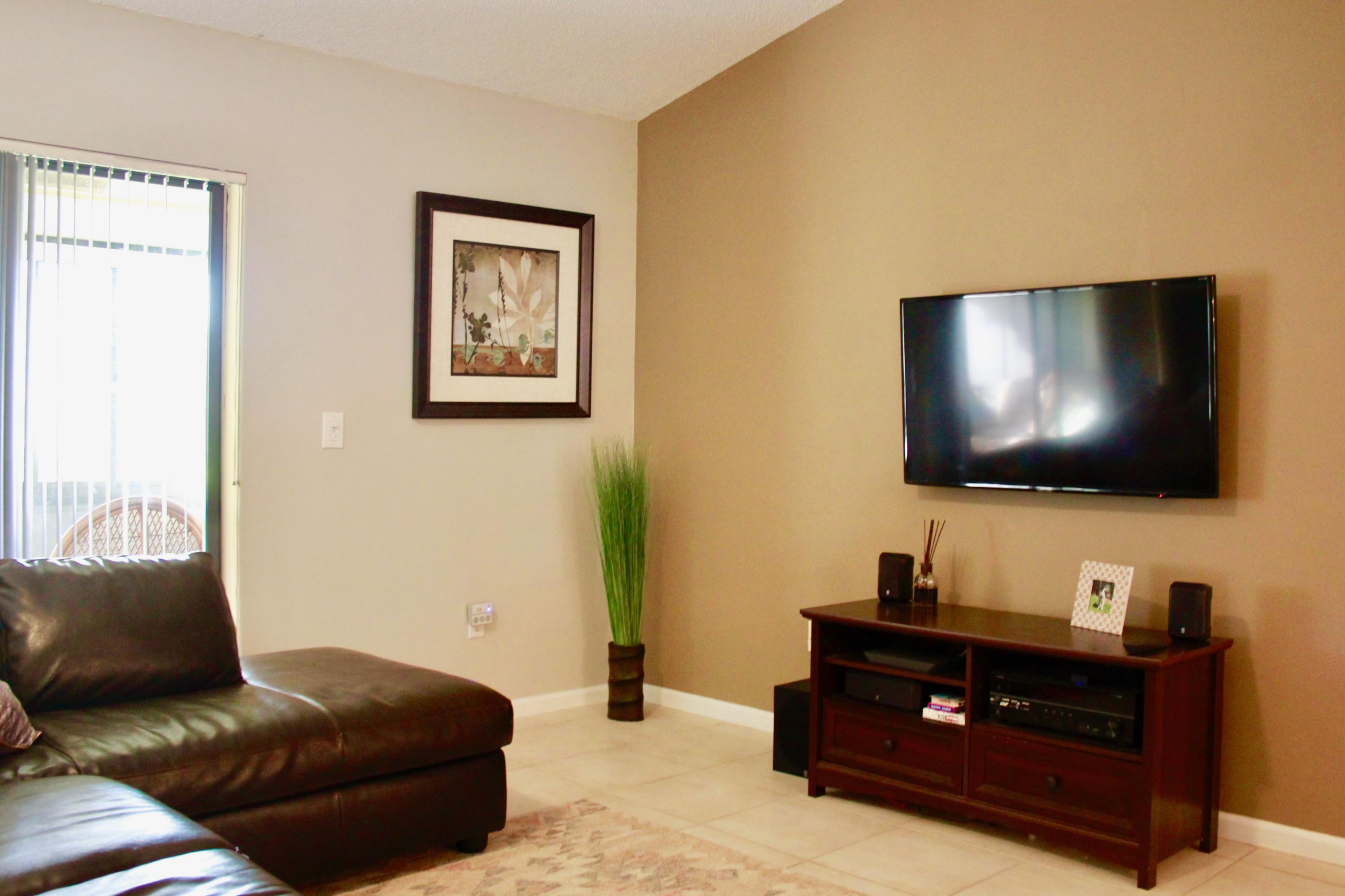 8986 Southwest 19th Street, Unit B Boca Raton, FL 33433 - Photo 16 of 55 a living room with furniture and a flat screen tv