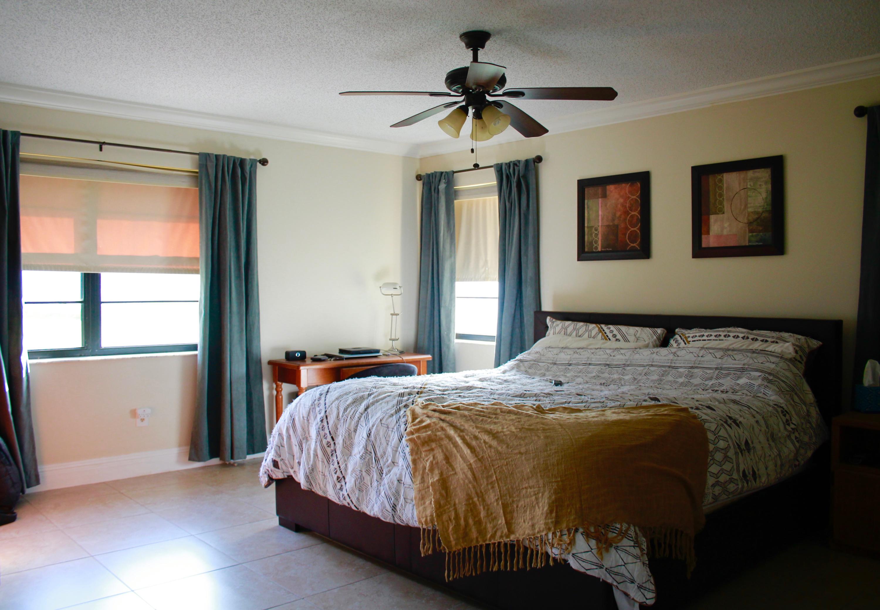 8986 Southwest 19th Street, Unit B Boca Raton, FL 33433 - Photo 23 of 55 a bedroom with a bed and a window