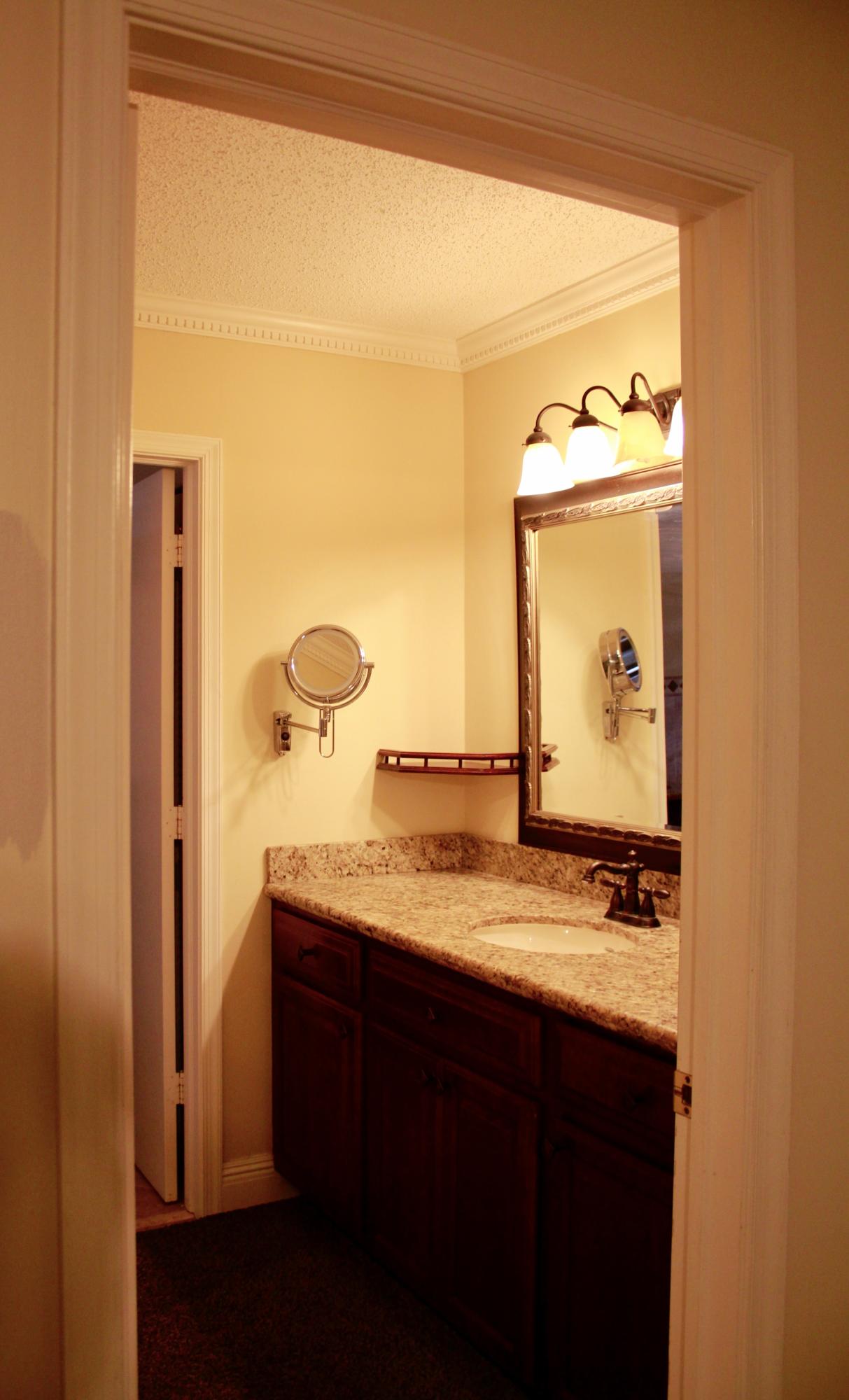 8986 Southwest 19th Street, Unit B Boca Raton, FL 33433 - Photo 26 of 55 a bathroom with a granite countertop sink and a mirror