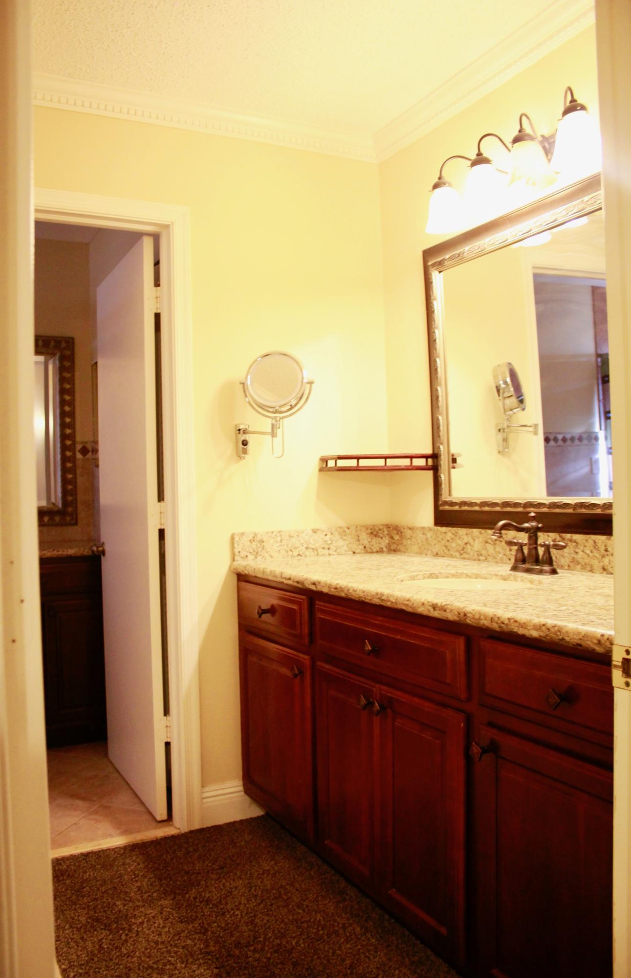 8986 Southwest 19th Street, Unit B Boca Raton, FL 33433 - Photo 27 of 55 a bathroom with a granite countertop sink and a mirror