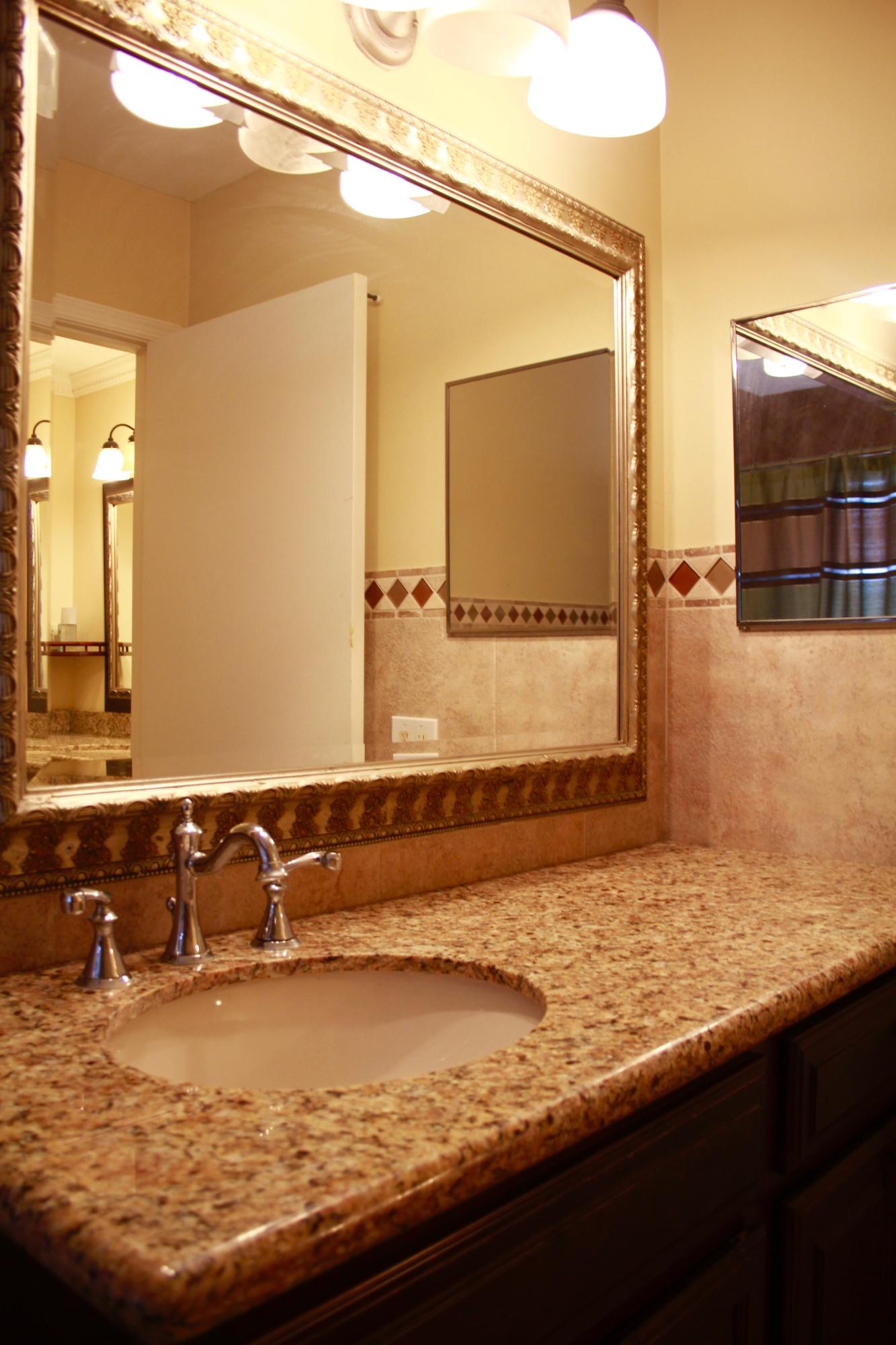 8986 Southwest 19th Street, Unit B Boca Raton, FL 33433 - Photo 29 of 55 a bathroom with a granite countertop sink and a mirror