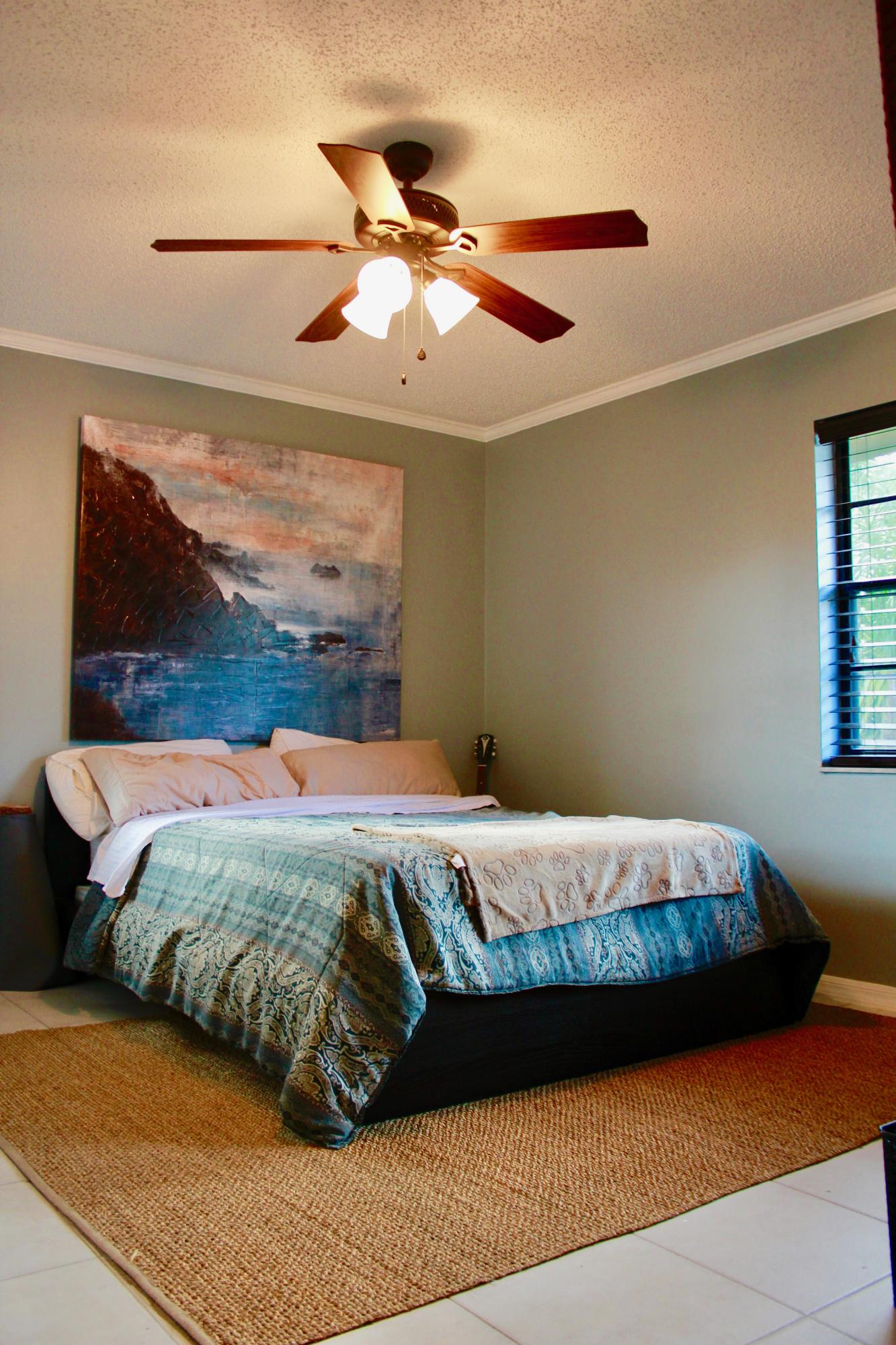 8986 Southwest 19th Street, Unit B Boca Raton, FL 33433 - Photo 34 of 55 a bed sitting in a bedroom next to a window