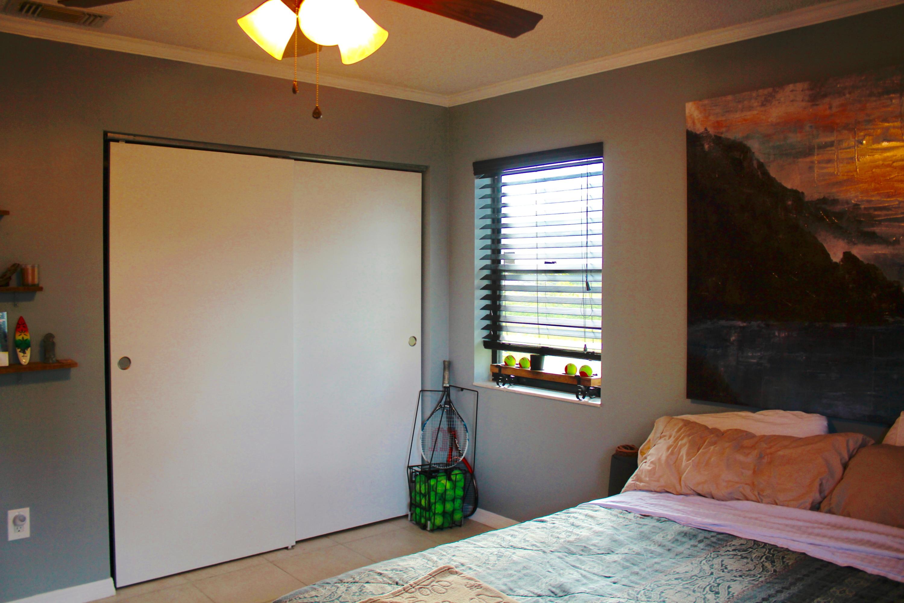 8986 Southwest 19th Street, Unit B Boca Raton, FL 33433 - Photo 35 of 55 a bedroom with a bed and a window
