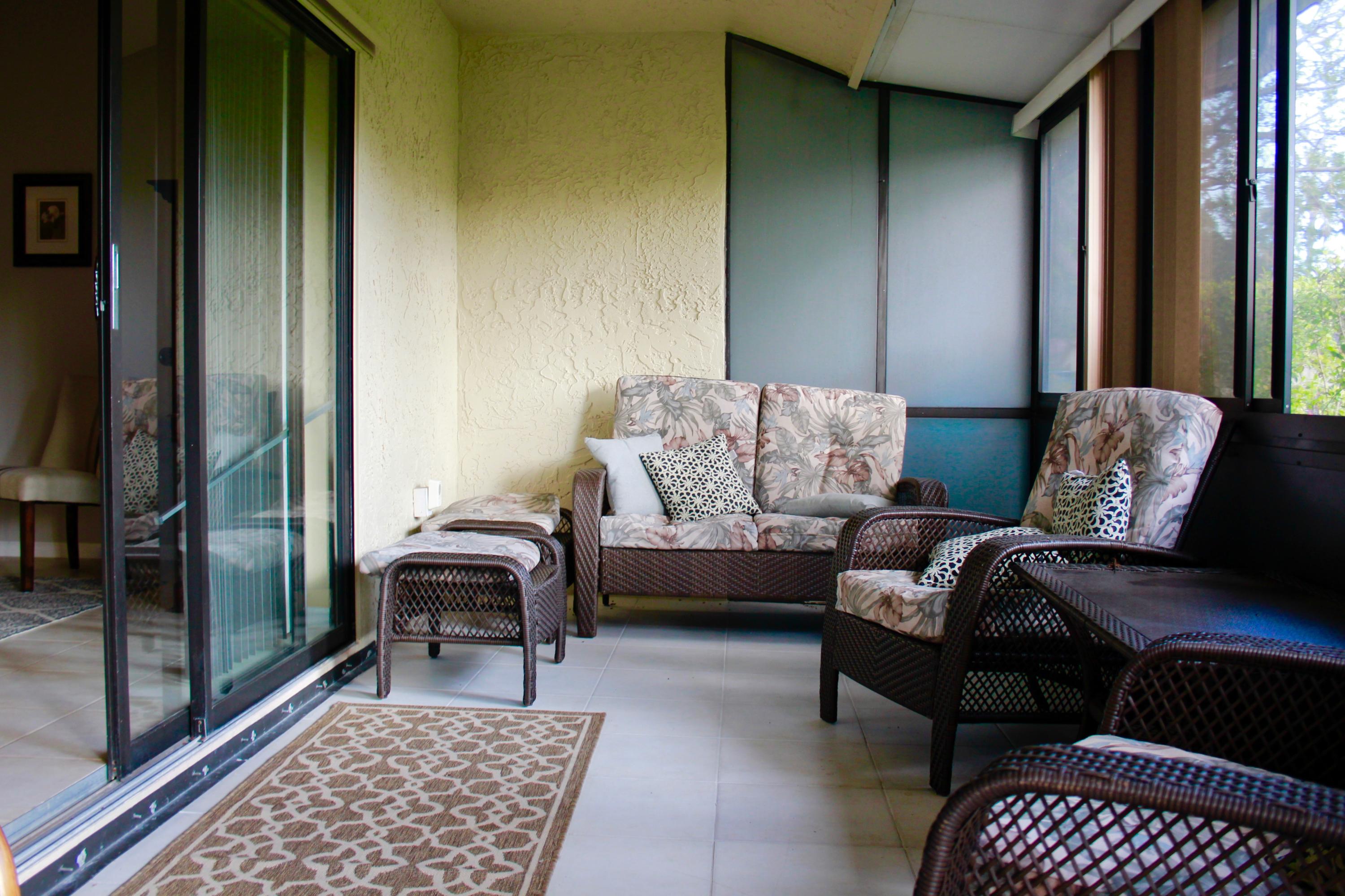 8986 Southwest 19th Street, Unit B Boca Raton, FL 33433 - Photo 39 of 55 a living room with furniture and a rug