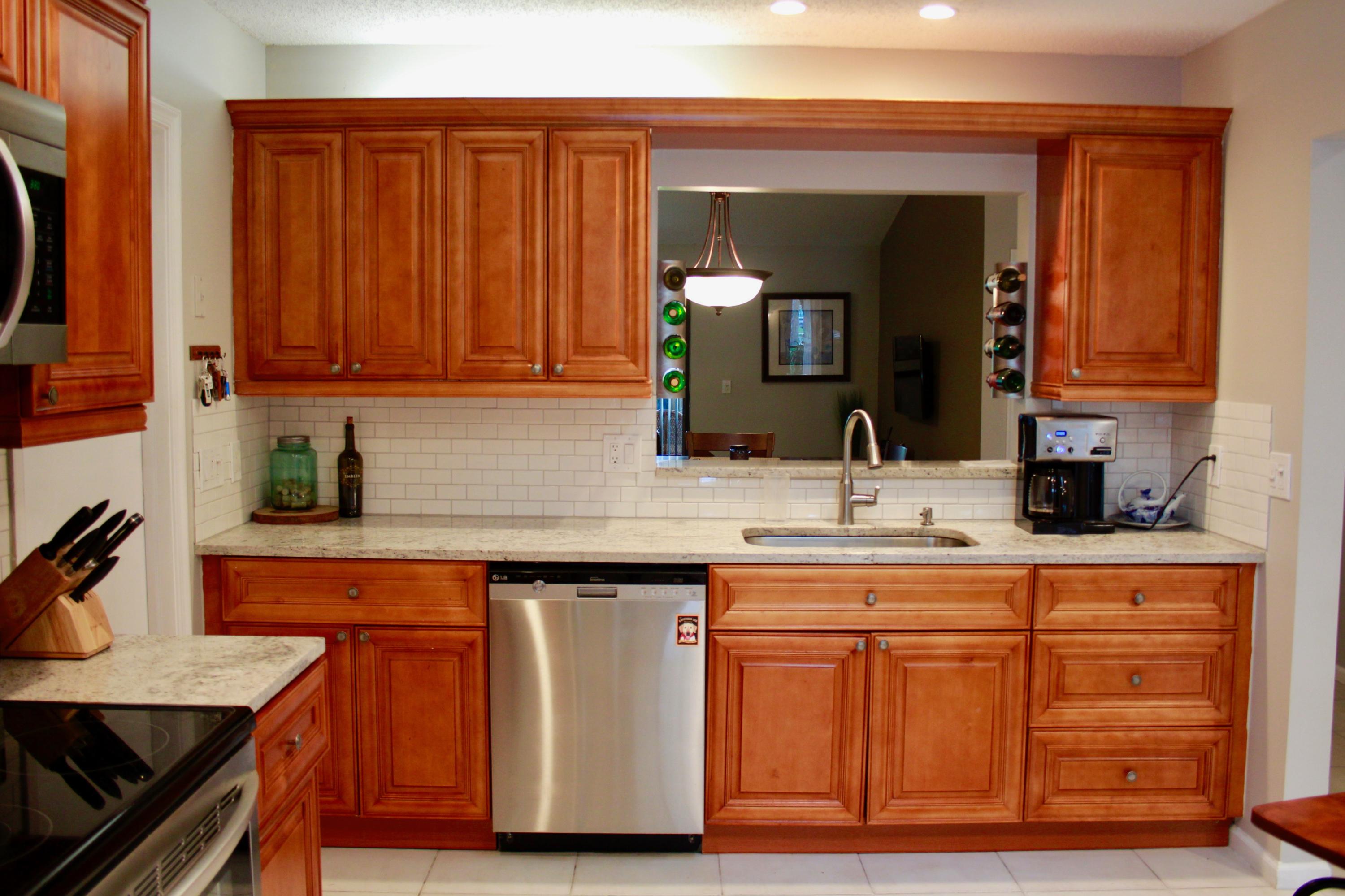 8986 Southwest 19th Street, Unit B Boca Raton, FL 33433 - Photo 4 of 55 a kitchen with cabinets and appliances