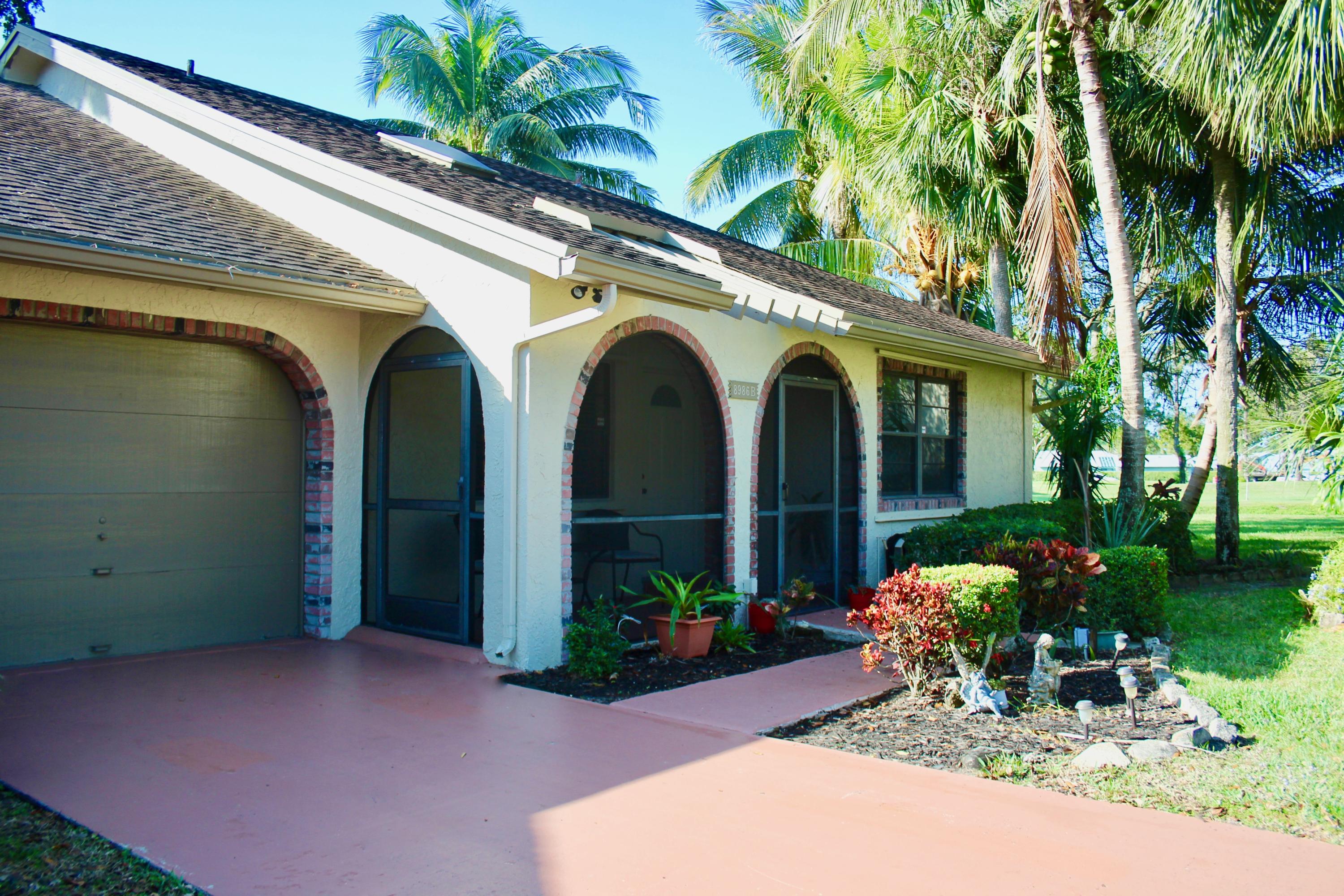 8986 Southwest 19th Street, Unit B Boca Raton, FL 33433 - Photo 43 of 55 a front view of a house with garden