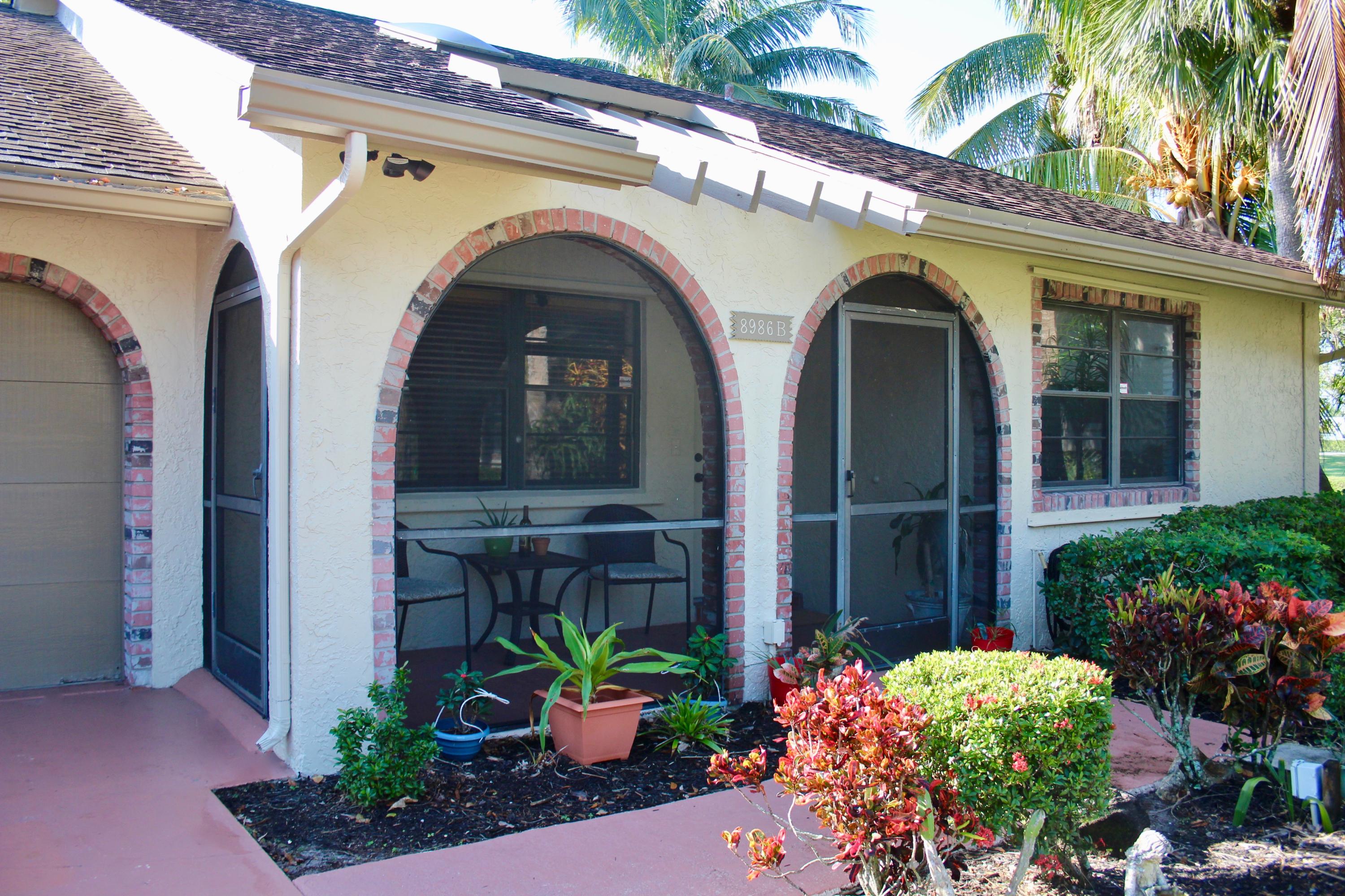 8986 Southwest 19th Street, Unit B Boca Raton, FL 33433 - Photo 44 of 55 a front view of a house with plants