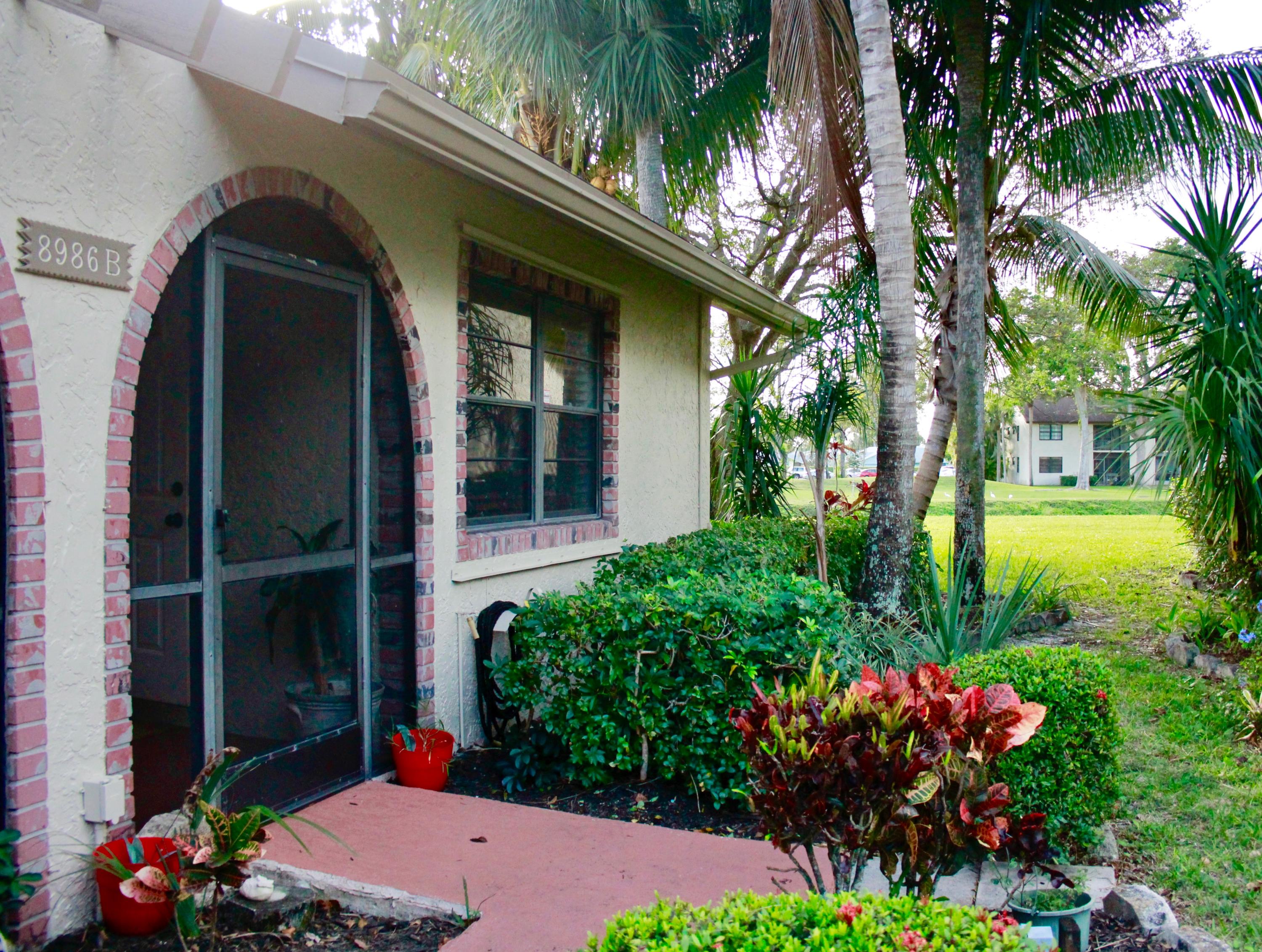 8986 Southwest 19th Street, Unit B Boca Raton, FL 33433 - Photo 47 of 55 a view of a house with a flower garden