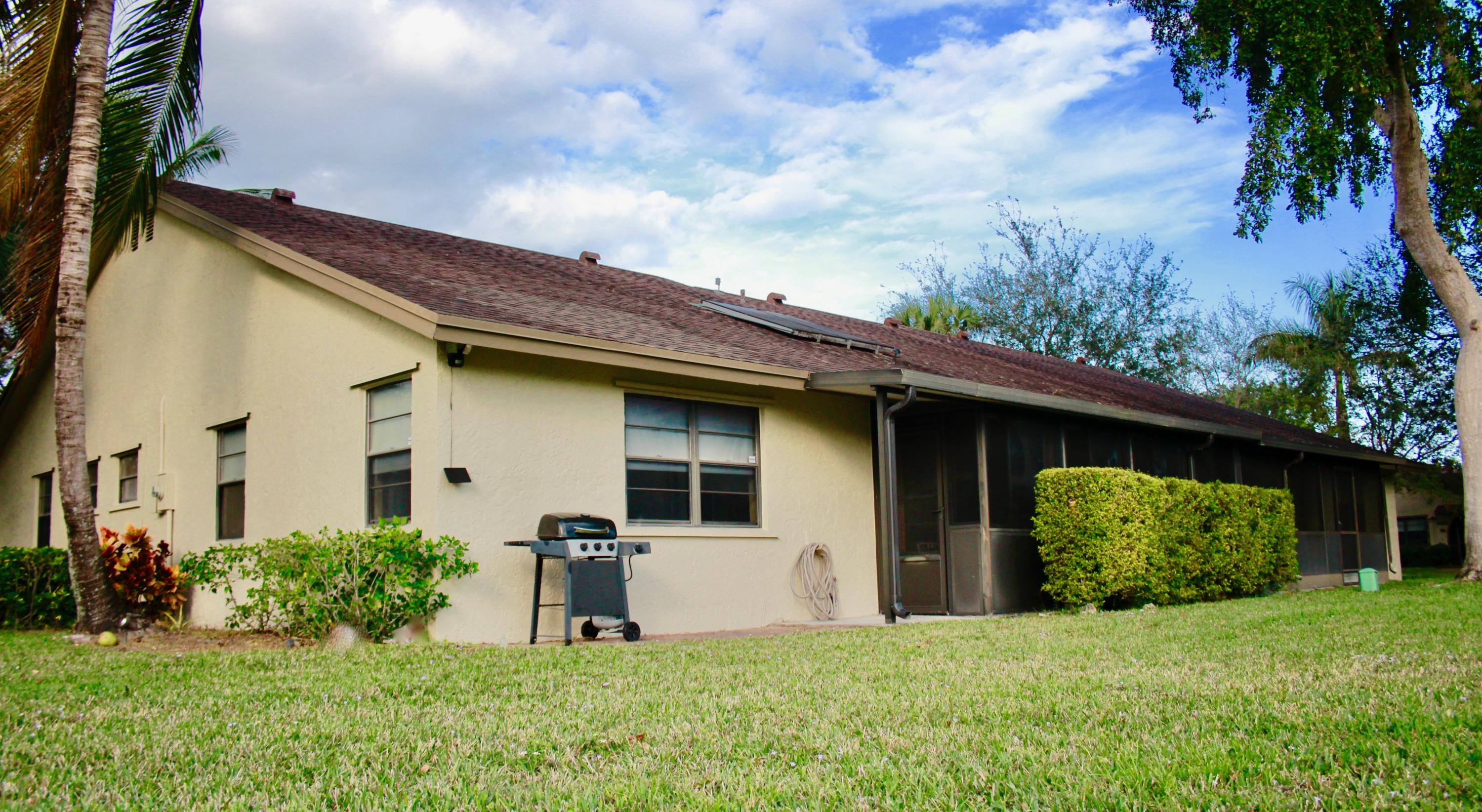 8986 Southwest 19th Street, Unit B Boca Raton, FL 33433 - Photo 48 of 55 a house view with a garden space
