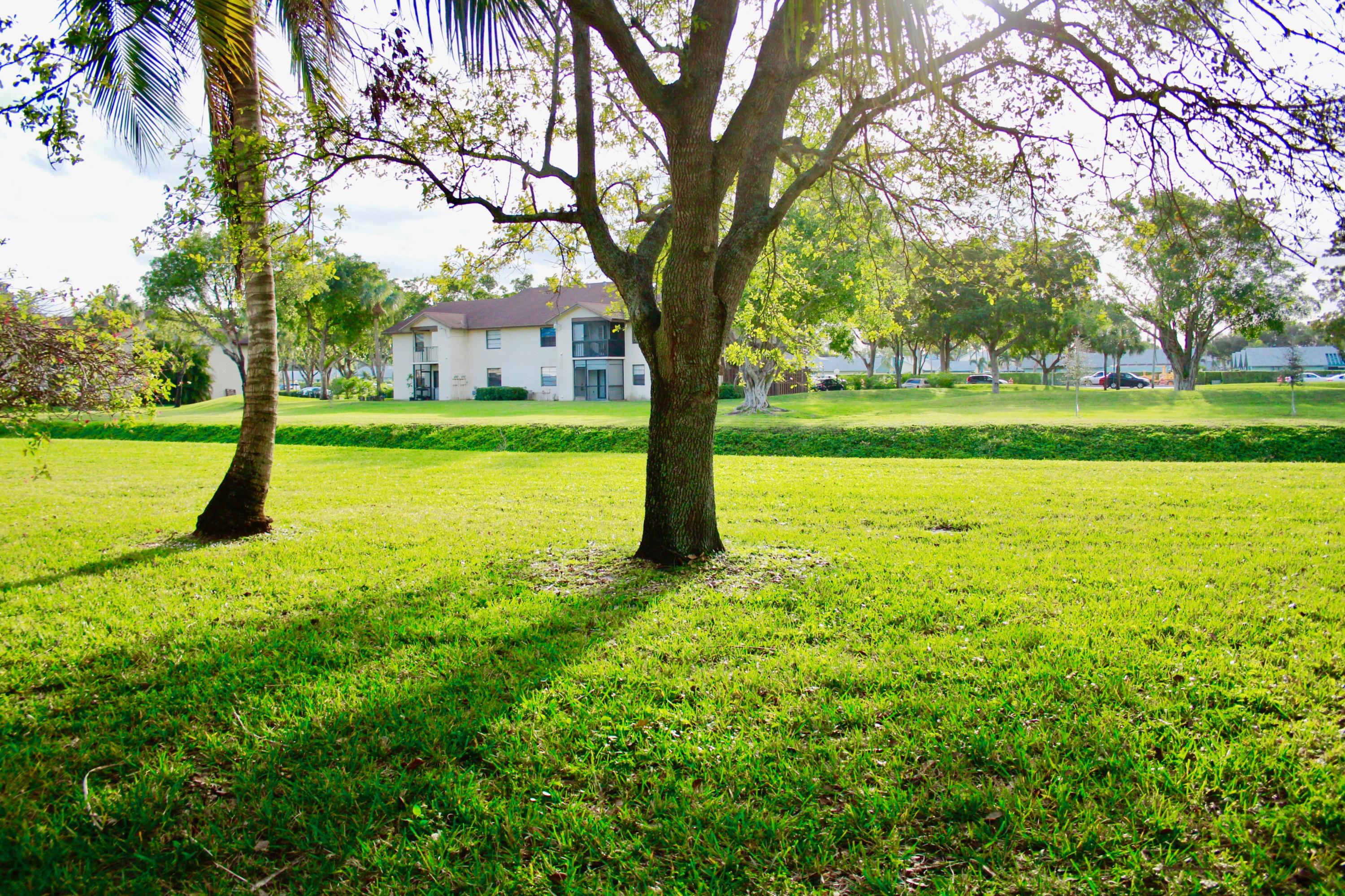 8986 Southwest 19th Street, Unit B Boca Raton, FL 33433 - Photo 51 of 55 a front view of a house with a big yard
