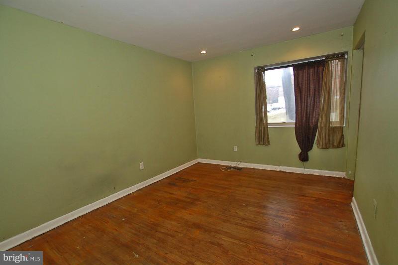 8622 Manchester Road, Unit 3 Silver Spring, MD 20901 - Photo 8 of 23 an empty room with wooden floor and windows