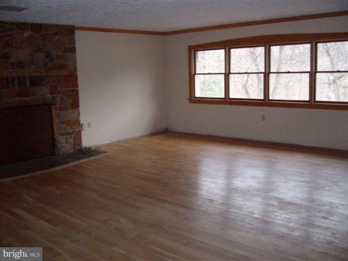 514 Redland Road Cross Junction, VA 22625 - Photo 13 of 24 an empty room with wooden floor and windows