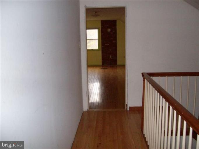 514 Redland Road Cross Junction, VA 22625 - Photo 16 of 24 a view of a hallway with wooden floor and staircase