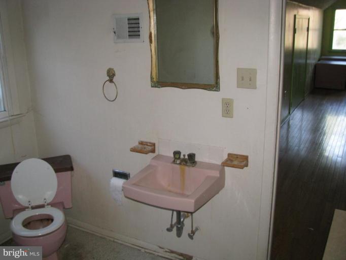 514 Redland Road Cross Junction, VA 22625 - Photo 20 of 24 a bathroom with a toilet a sink and mirror