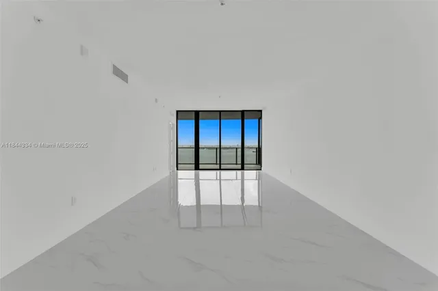 a living room with furniture a rug and a flat screen tv