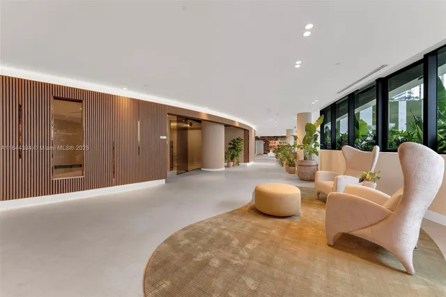 a living room with furniture and large windows