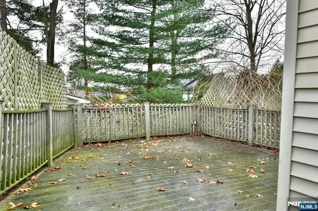 a view of backyard of house with large trees