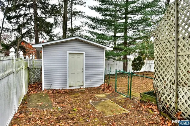 a view of a backyard with large trees