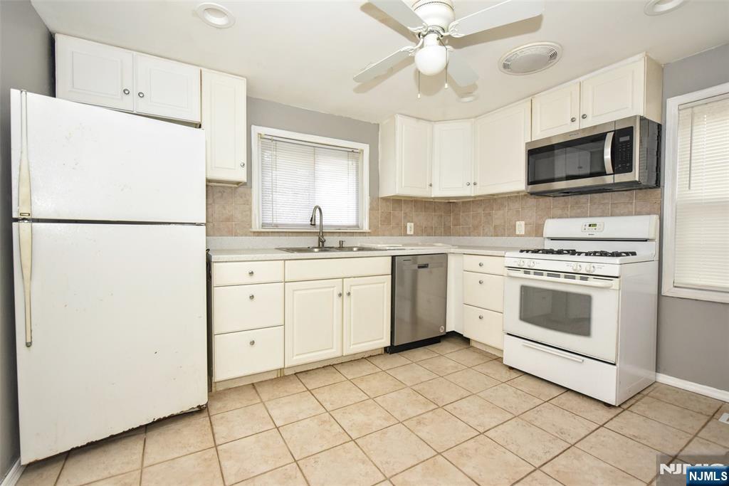 34 Summit Avenue Waldwick, NJ 07463 - Photo 5 of 16 a kitchen with white cabinets and white appliances
