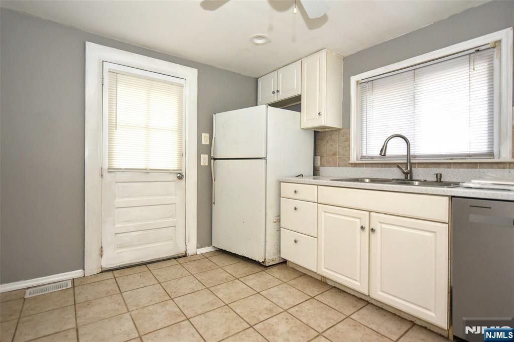 34 Summit Avenue Waldwick, NJ 07463 - Photo 7 of 16 a kitchen with white cabinets and white appliances
