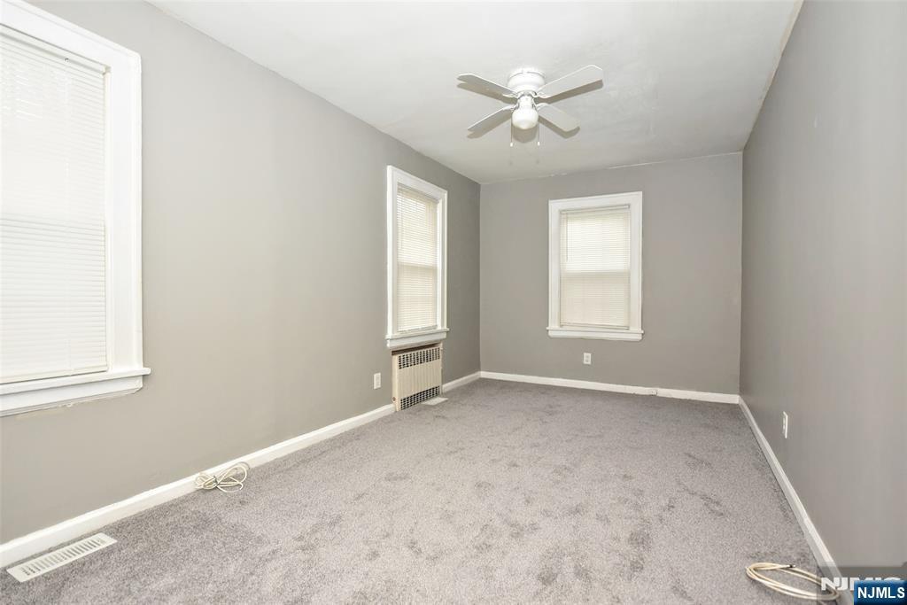 34 Summit Avenue Waldwick, NJ 07463 - Photo 8 of 16 an empty room with windows and fan