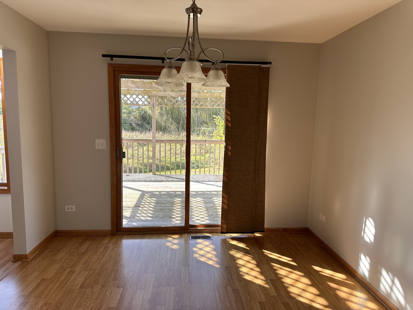26358 South Evergreen Lane Channahon, IL 60410 - Photo 12 of 28 a view of an empty room with wooden floor and a window