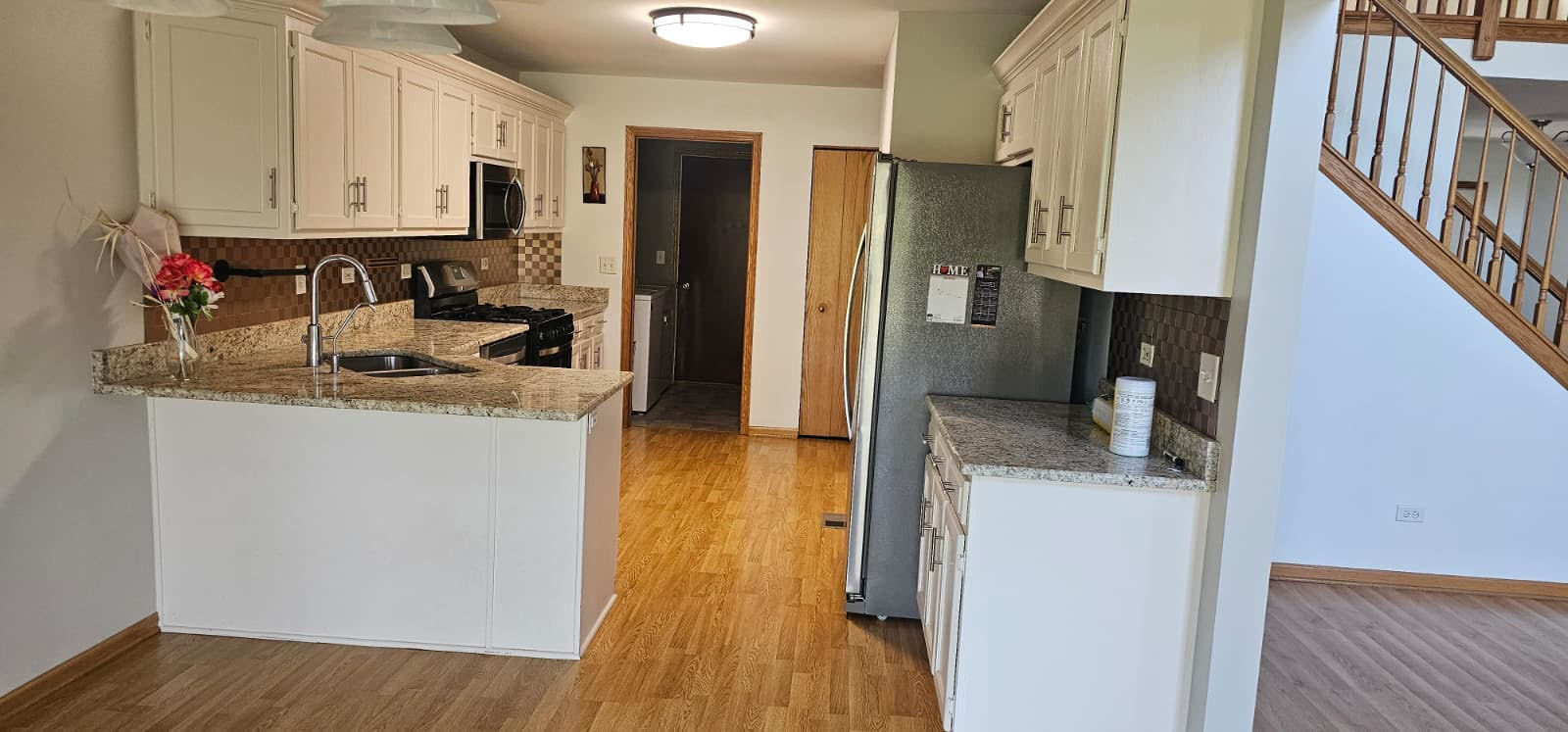 26358 South Evergreen Lane Channahon, IL 60410 - Photo 14 of 28 a kitchen with stainless steel appliances granite countertop a sink stove refrigerator and cabinets