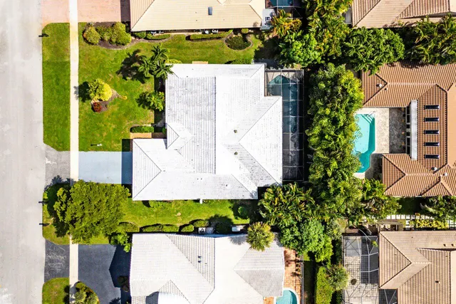 an aerial view of a house with a yard and garden