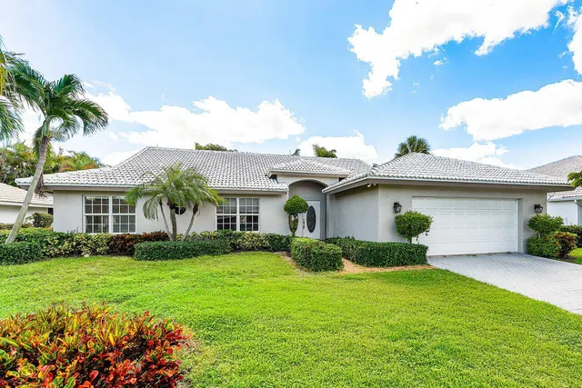 a front view of house with yard and green space