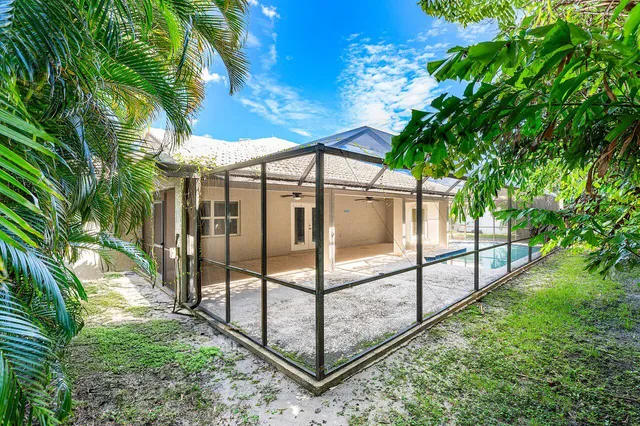 an aerial view of a house with a yard and trees