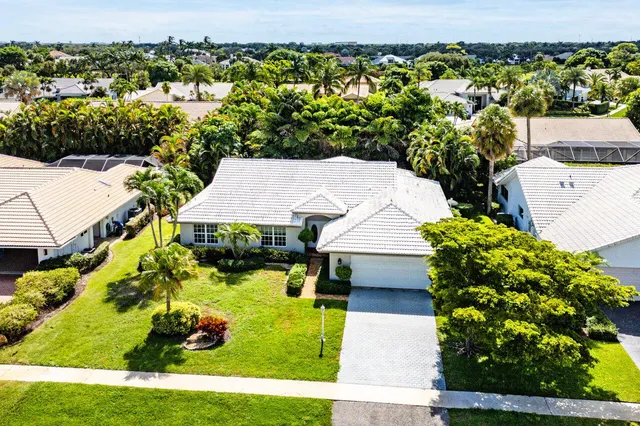 an aerial view of residential houses with outdoor space and lake view