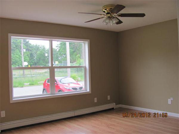 167 Fitch Road Clinton, MA 01510 - Photo 13 of 26 an empty room with wooden floor and windows