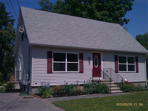 167 Fitch Road Clinton, MA 01510 - Photo 2 of 26 a brick house with a yard potted plants and large tree