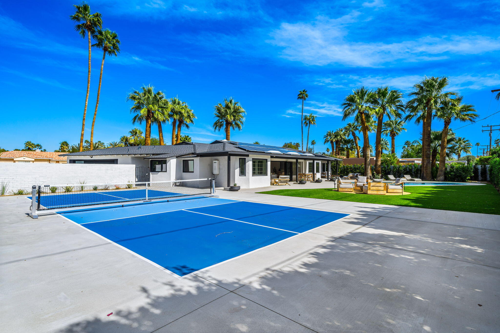 1037 Tamarisk Road Palm Springs, CA 92262 - Photo 25 of 31 a view of swimming pool with outdoor seating and yard