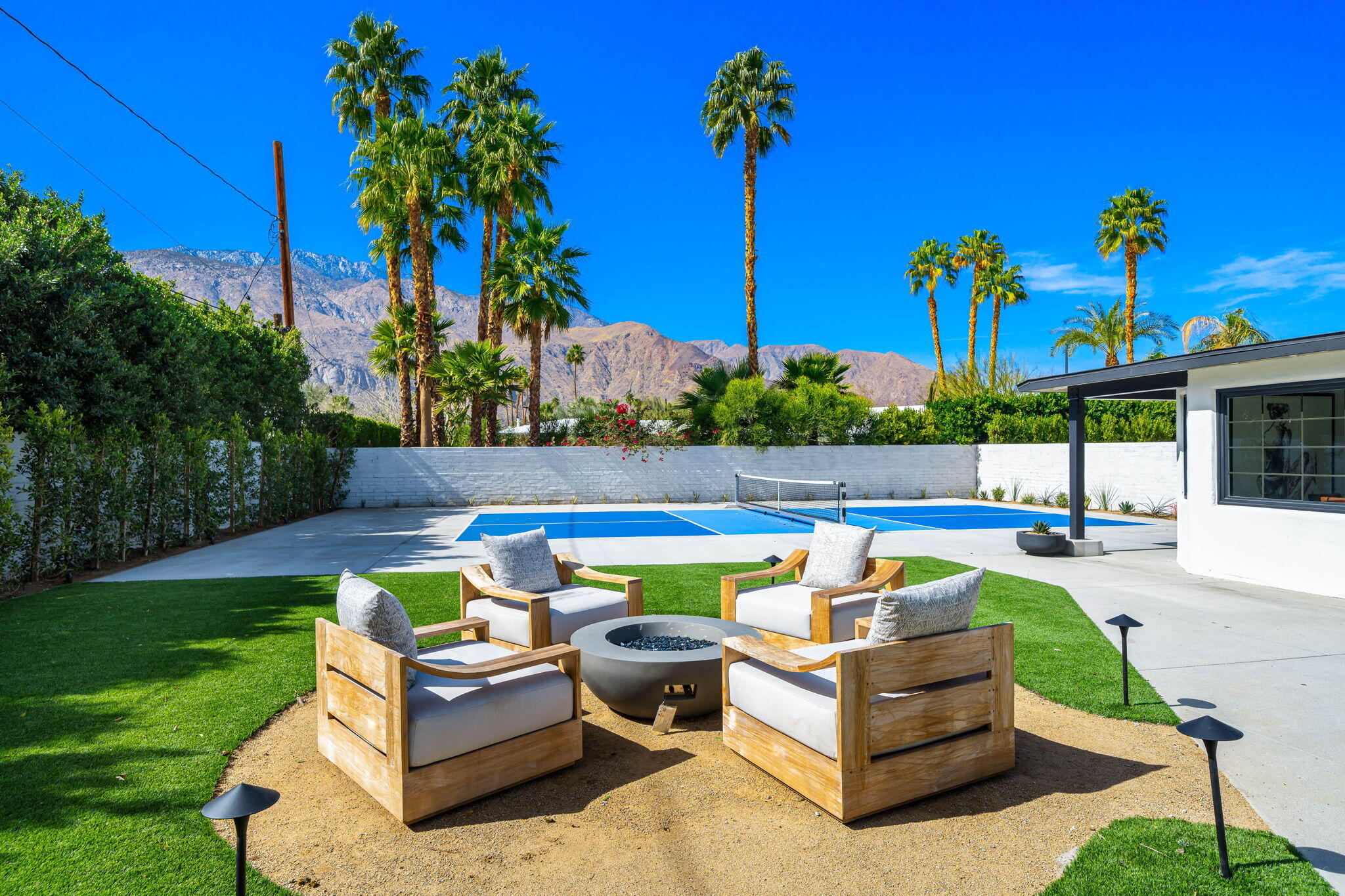 1037 Tamarisk Road Palm Springs, CA 92262 - Photo 26 of 31 a view of swimming pool with a table and chairs