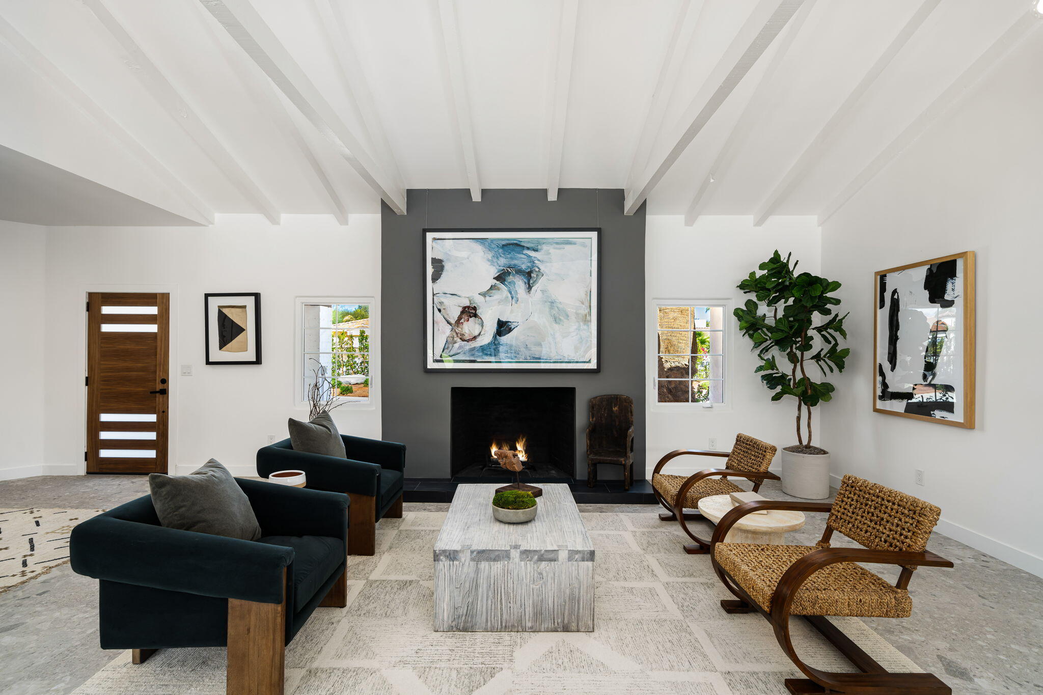 1037 Tamarisk Road Palm Springs, CA 92262 - Photo 6 of 31 a living room with furniture a fireplace and wall paintings