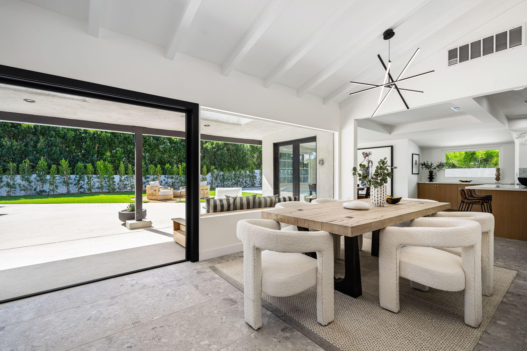 1037 Tamarisk Road Palm Springs, CA 92262 - Photo 9 of 31 a dining room with furniture and a floor to ceiling window