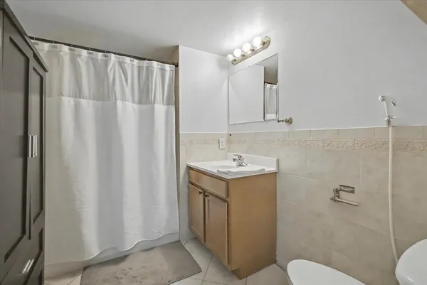 a bathroom with a sink a toilet and shower curtain