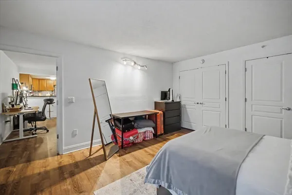 a bed room with a bed and a chair
