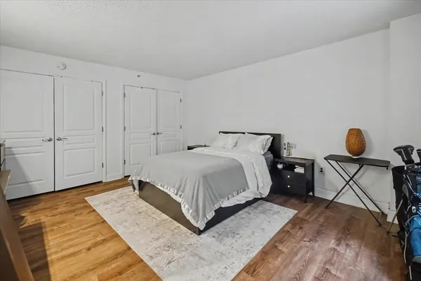 a bedroom with a bed and cabinets