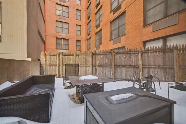 a view of a patio with couches table and chairs and potted plants