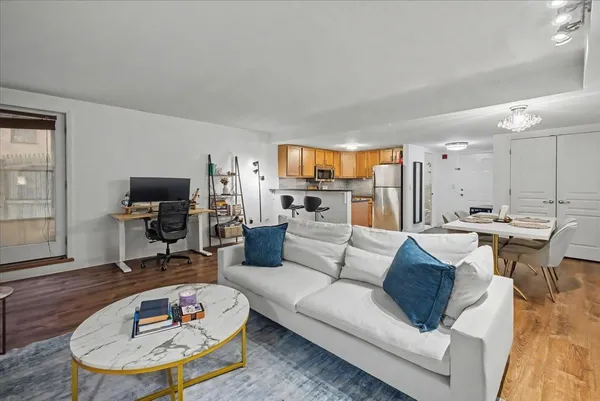 a living room with furniture and a wooden floor