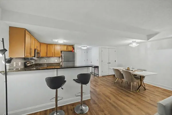 a kitchen with a counter space a sink cabinets and wooden floor