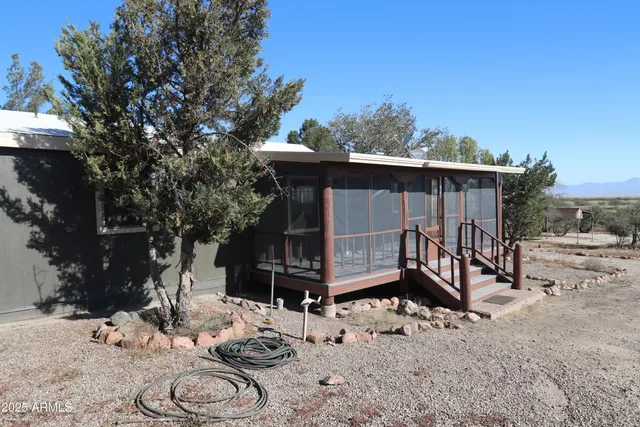 a view of a house with a yard covered with snow in the background