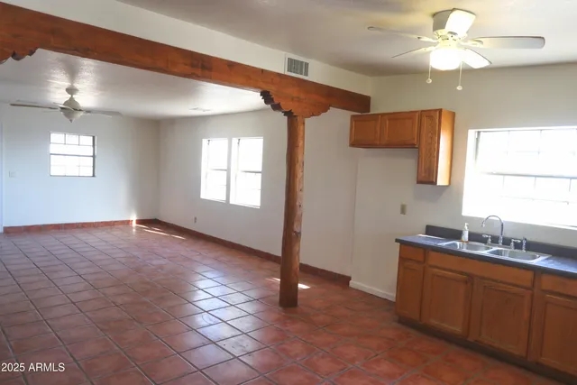 a view of a kitchen with a sink and a window