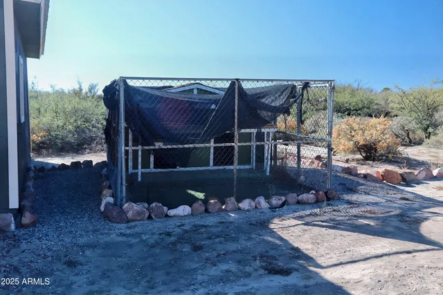 a view of a patio with table and chairs with wooden floor and fence