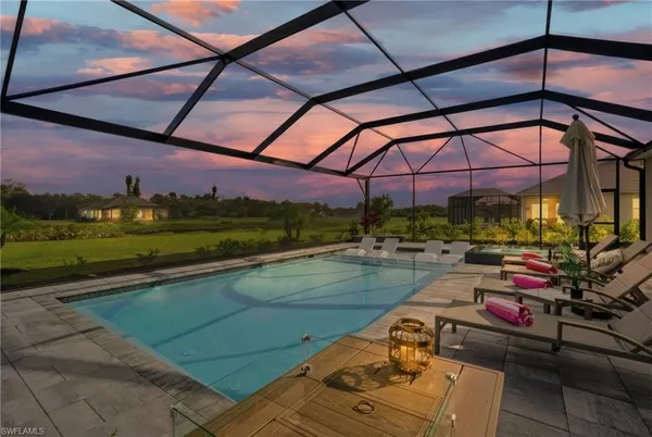 a view of a swimming pool with a couches chairs and a yard