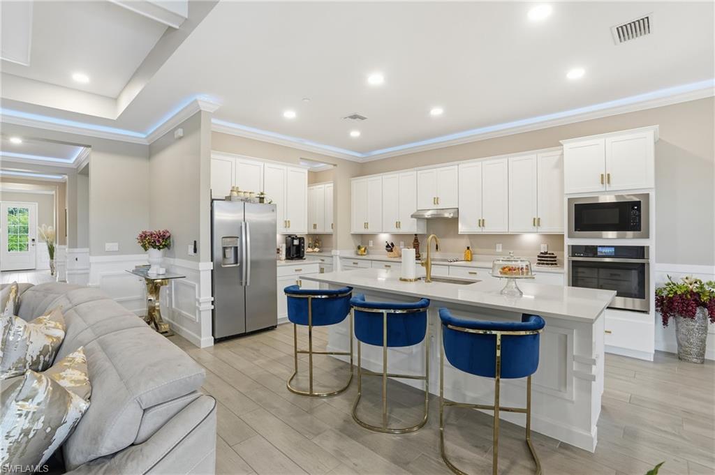 17120 Serengeti Circle Alva, FL 33920 - Photo 48 of 50 a kitchen with stainless steel appliances kitchen island granite countertop a sink and cabinets