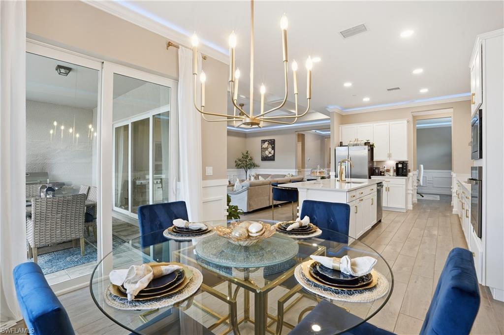 17120 Serengeti Circle Alva, FL 33920 - Photo 18 of 50 a living room with furniture kitchen view and a chandelier
